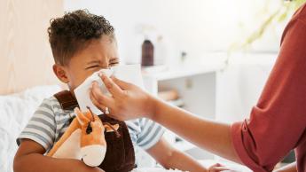 kid blowing nose