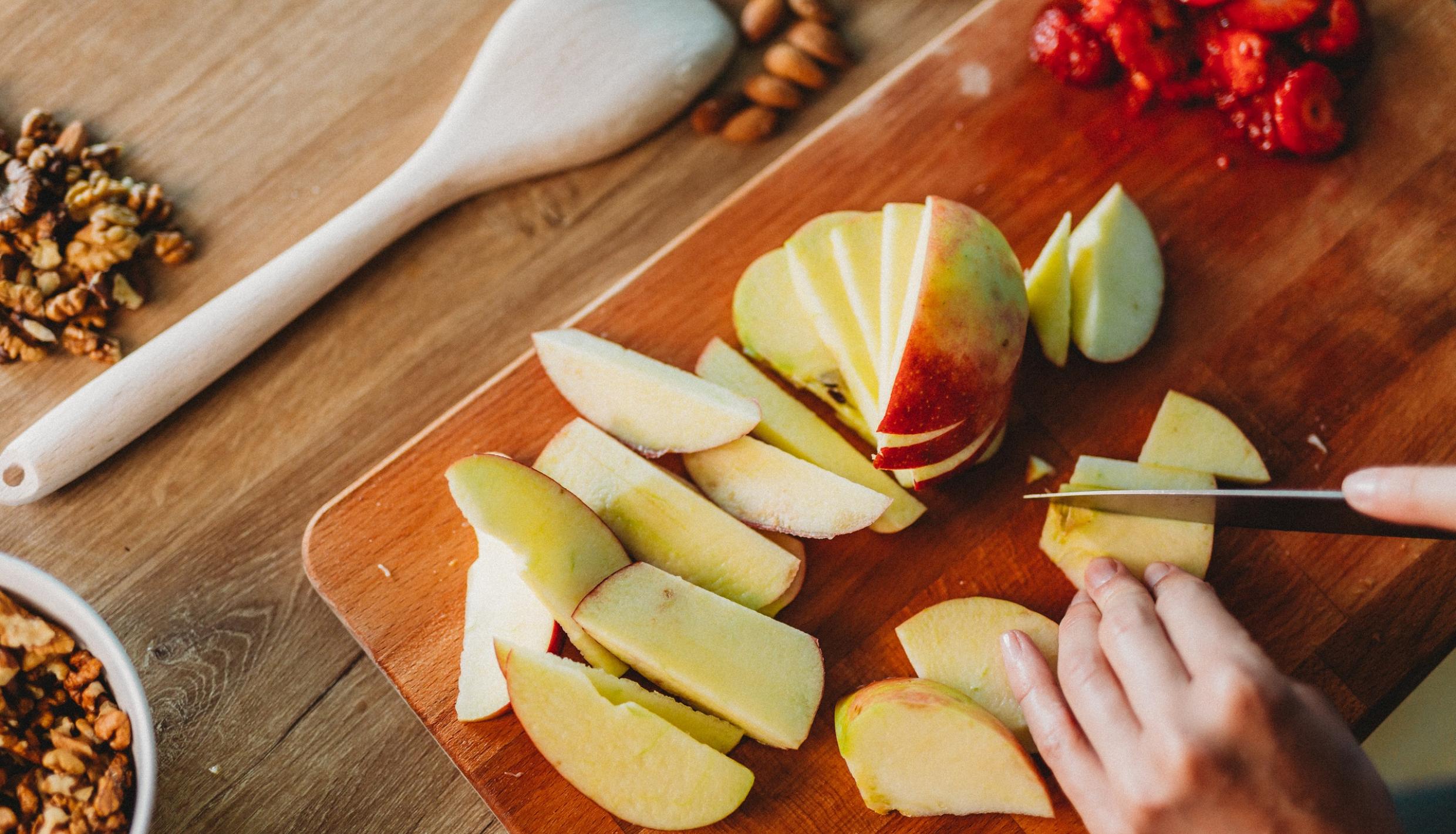 photo of someone cutting apples