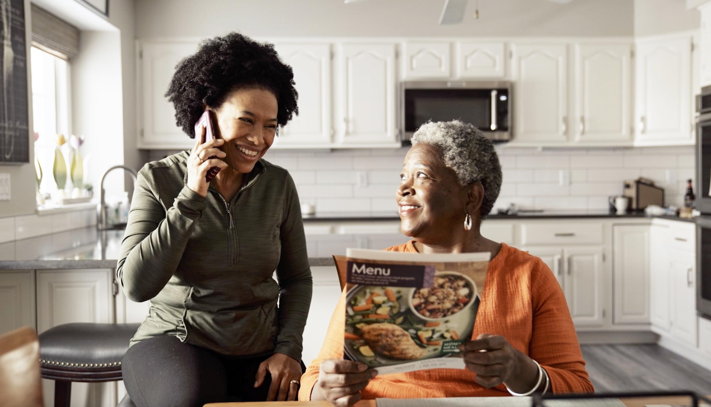 Woman on phone in kitchen