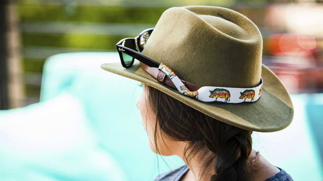 lady facing back using a hat showing the eye glasses retainer