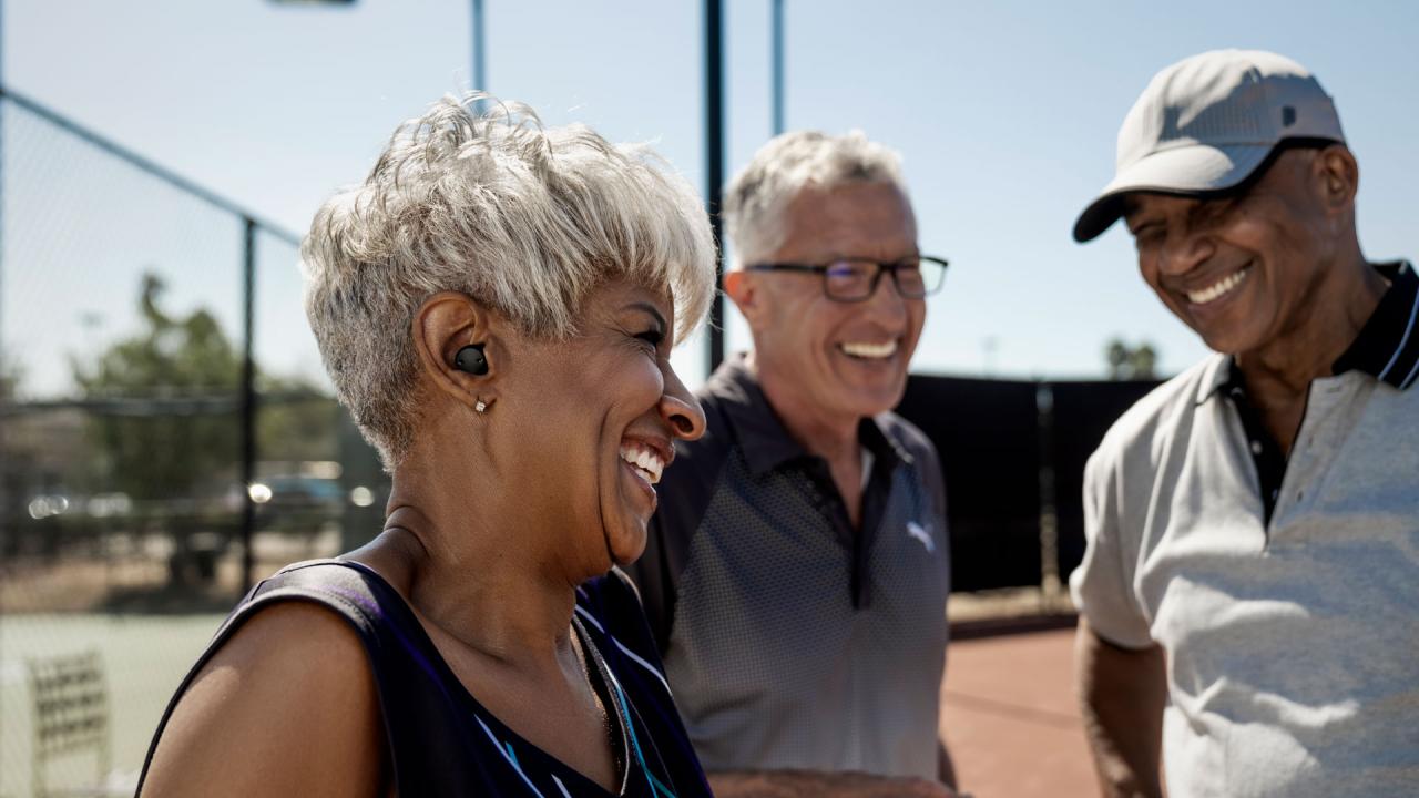 Three people at tennis court