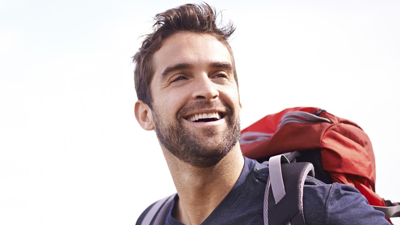 smiling man with backpack