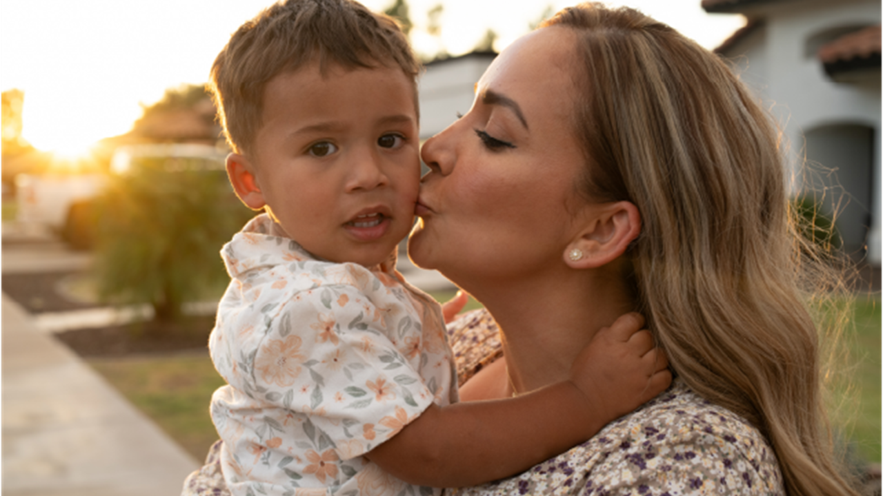 Mom kissing son