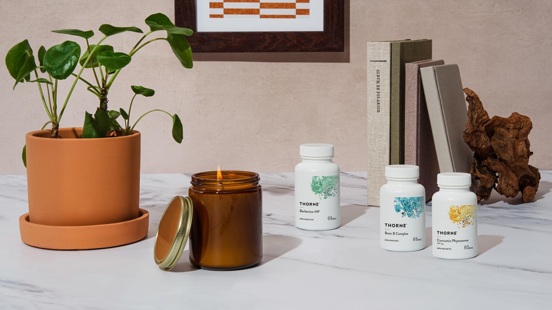 Plant, candle and vitamins on a table
