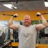 A man doing an arm exercise in a gym.